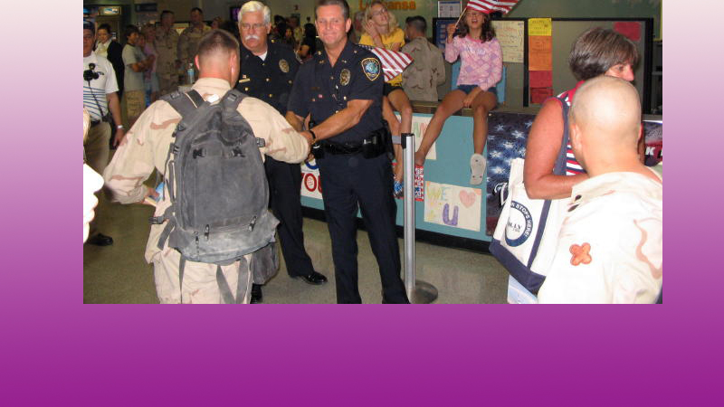 Lt. Rodney Cunningham and Chief Tommy Ingram of the Colleyville PD welcome troops home at DFW. June 17, 2005